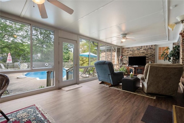 sunroom / solarium featuring plenty of natural light and wood finished floors