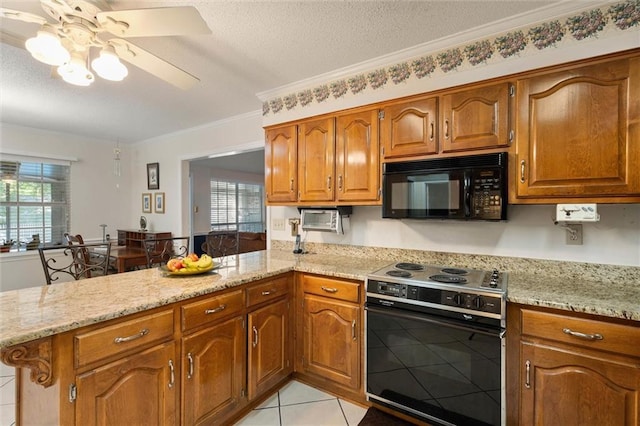 kitchen featuring brown cabinets, ceiling fan, black microwave, and electric range oven