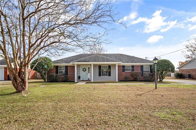 ranch-style home featuring central air condition unit, a front yard, and brick siding