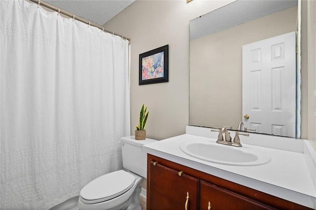 bathroom with toilet, a textured ceiling, and vanity