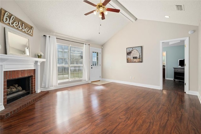 unfurnished living room featuring ceiling fan, lofted ceiling with beams, dark hardwood / wood-style floors, a textured ceiling, and a fireplace