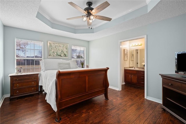 bedroom with baseboards, a raised ceiling, dark wood finished floors, and crown molding