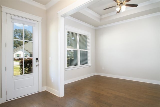 interior space featuring dark wood finished floors, a raised ceiling, baseboards, and ornamental molding