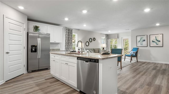 10471 Lowell St W, Mobile, AL 36695 - kitchen with stainless steel appliances, a sink, recessed lighting, an island with sink, and light wood finished floors
