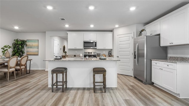 10471 Lowell St W, Mobile, AL 36695 - kitchen with appliances with stainless steel finishes, light wood-type flooring, white cabinets, and recessed lighting
