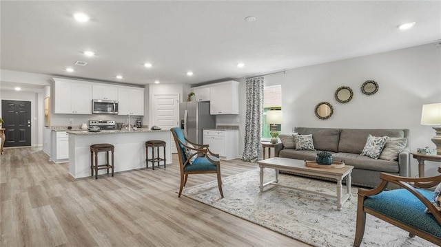 10471 Lowell St W, Mobile, AL 36695 - living area with light wood-style flooring and recessed lighting