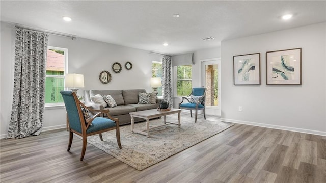 10471 Lowell St W, Mobile, AL 36695 - living room featuring wood finished floors, healthy amount of natural light, recessed lighting, and baseboards
