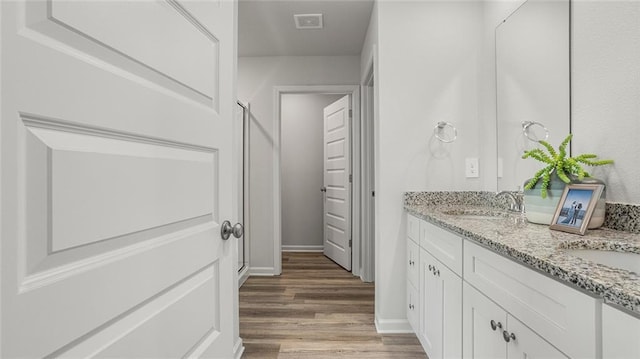 10471 Lowell St W, Mobile, AL 36695 - bathroom featuring double vanity, wood finished floors, a stall shower, and baseboards