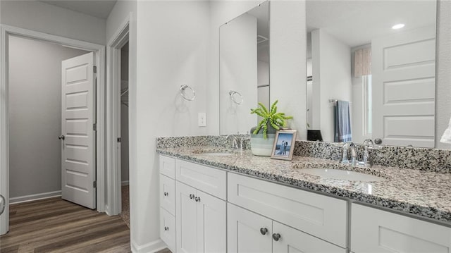 10471 Lowell St W, Mobile, AL 36695 - full bathroom featuring wood finished floors, double vanity, and baseboards