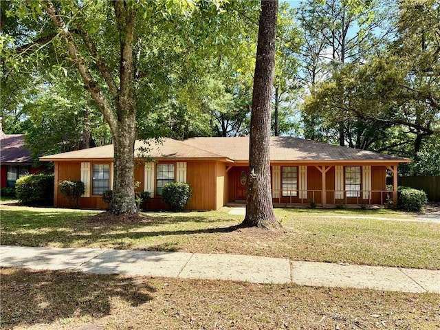 ranch-style house featuring a porch and a front yard