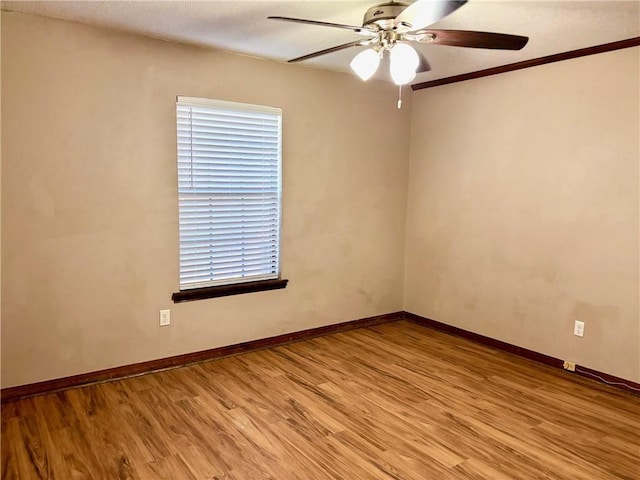 unfurnished room featuring ceiling fan, baseboards, and light wood-type flooring