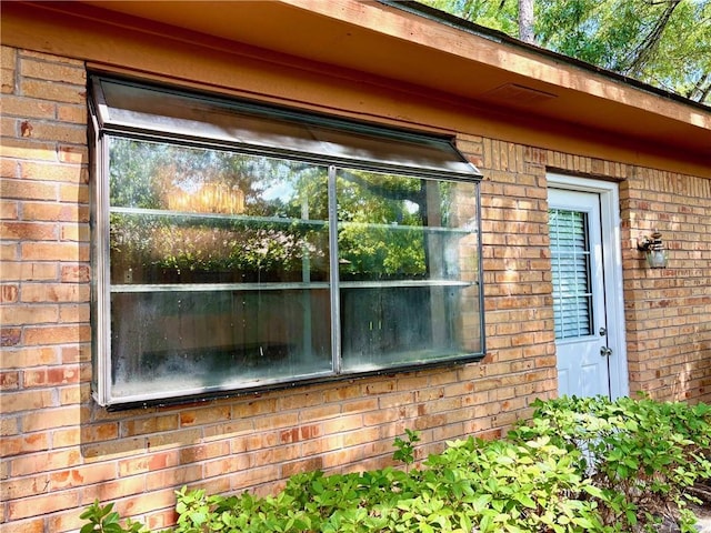 view of side of property featuring brick siding