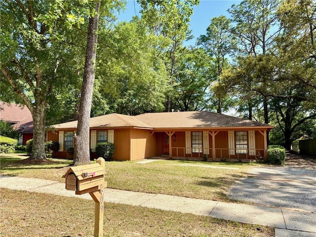 ranch-style house with a porch and a front yard