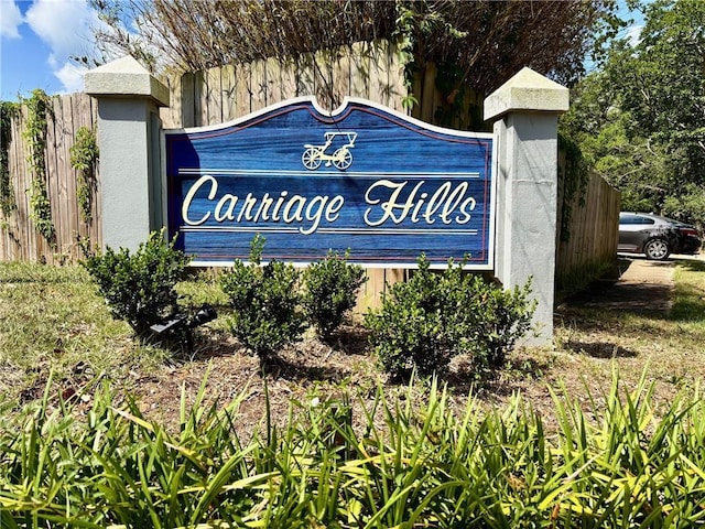 community sign featuring fence