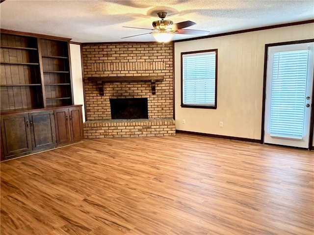 unfurnished living room featuring crown molding, a textured ceiling, ceiling fan, and light wood finished floors
