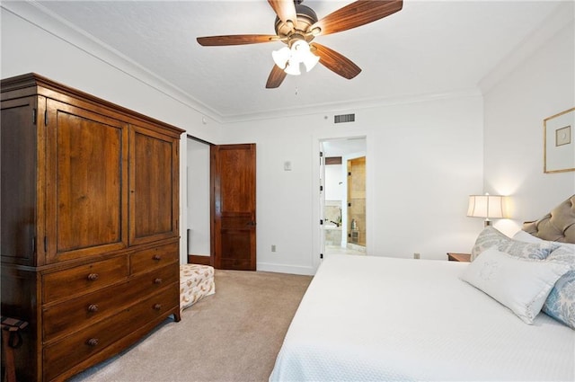 carpeted bedroom with ensuite bath, ceiling fan, and crown molding