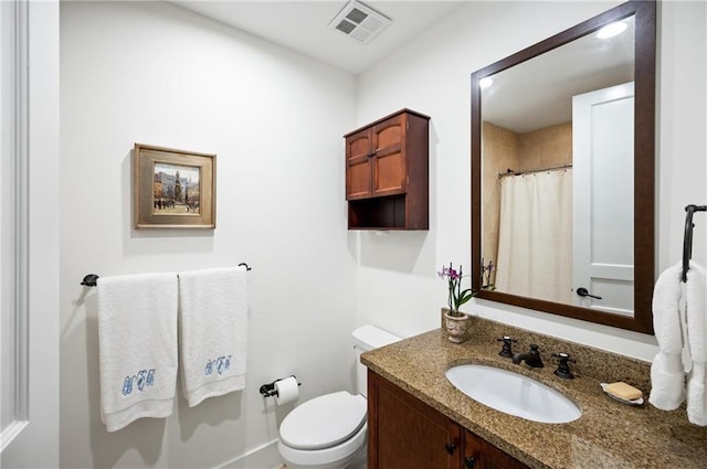 bathroom featuring vanity, toilet, and curtained shower