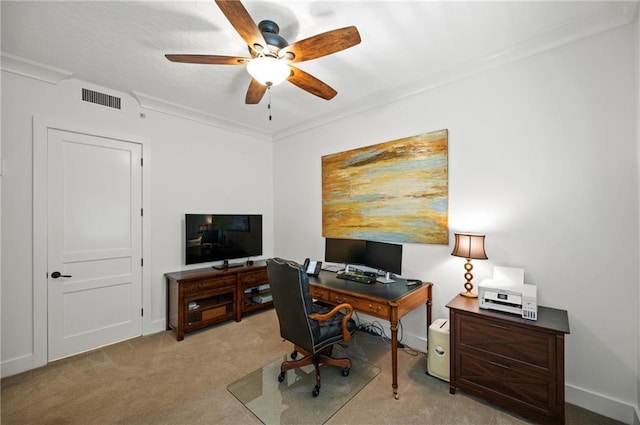 home office featuring light carpet, crown molding, and ceiling fan