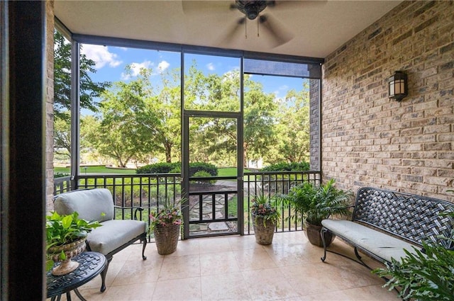 sunroom / solarium featuring a wealth of natural light and ceiling fan