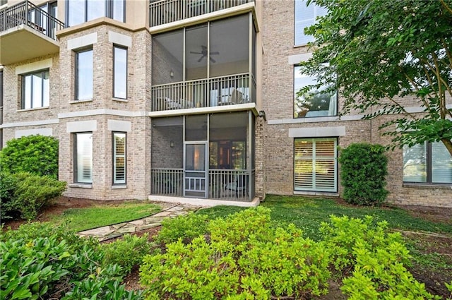 rear view of property featuring ceiling fan