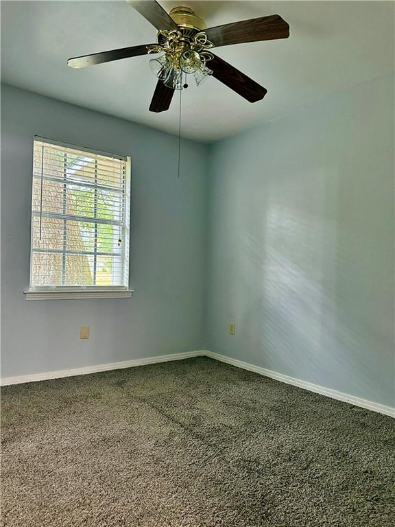 unfurnished room with carpet floors and ceiling fan