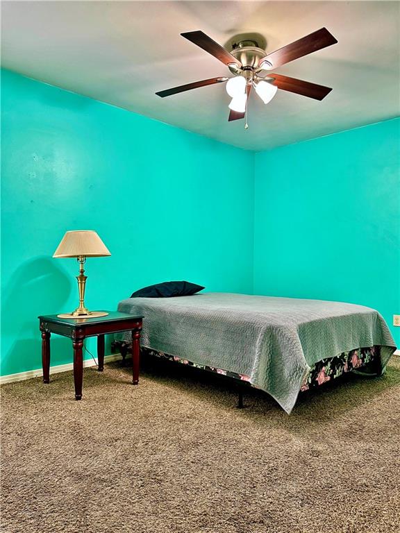 bedroom with ceiling fan and carpet flooring