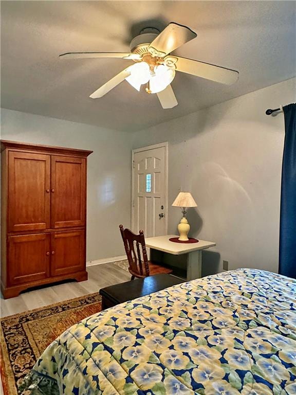 bedroom featuring light wood-type flooring and ceiling fan