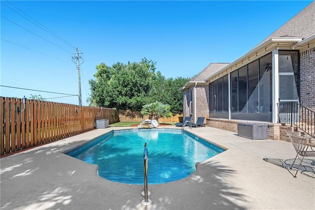 view of pool featuring a sunroom and a patio area