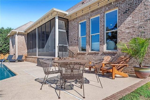 view of patio / terrace featuring a sunroom