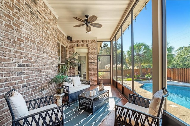 sunroom / solarium featuring ceiling fan and plenty of natural light