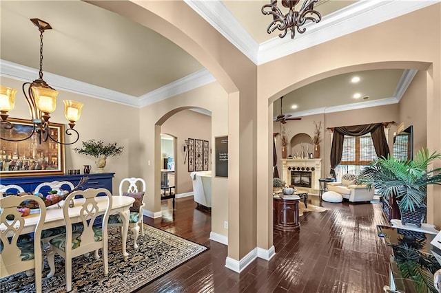 dining space featuring ornamental molding, a notable chandelier, and dark hardwood / wood-style floors