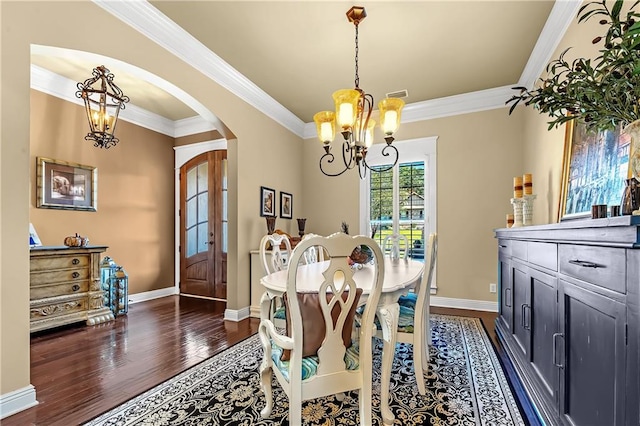 dining room with dark hardwood / wood-style floors and crown molding