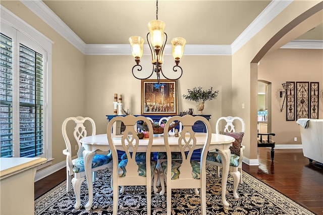 dining area featuring an inviting chandelier, crown molding, and dark hardwood / wood-style flooring