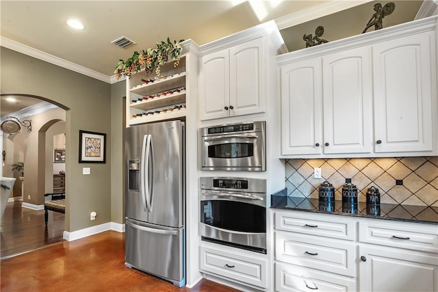 kitchen featuring tasteful backsplash, dark stone counters, white cabinetry, ornamental molding, and stainless steel refrigerator with ice dispenser