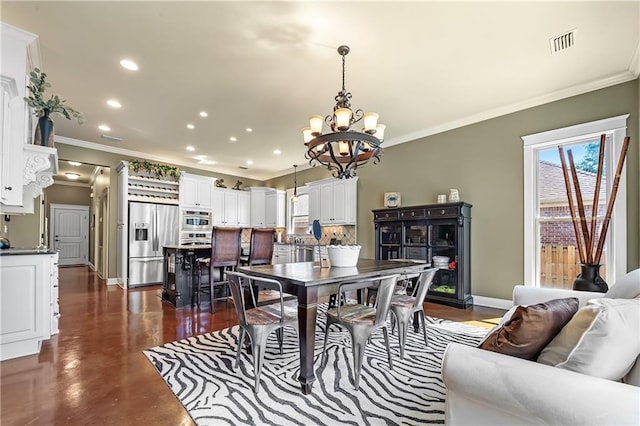 dining space featuring ornamental molding and a chandelier