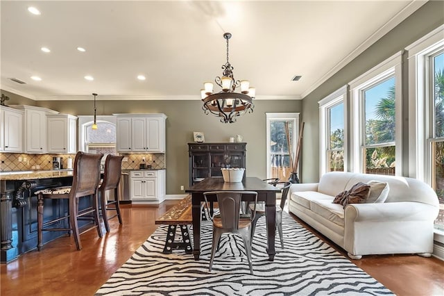 dining room featuring a notable chandelier and crown molding