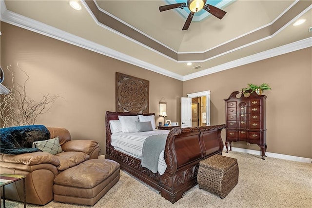 carpeted bedroom with ceiling fan, a raised ceiling, and ornamental molding