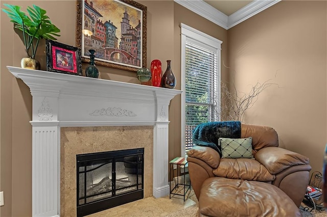 living area with a fireplace, crown molding, and carpet flooring