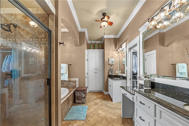 bathroom featuring ceiling fan, ornamental molding, vanity, and independent shower and bath