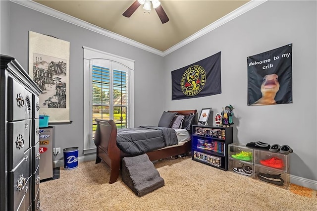 carpeted bedroom featuring ornamental molding and ceiling fan