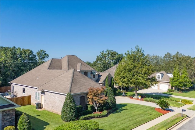 view of property exterior with a garage and a yard