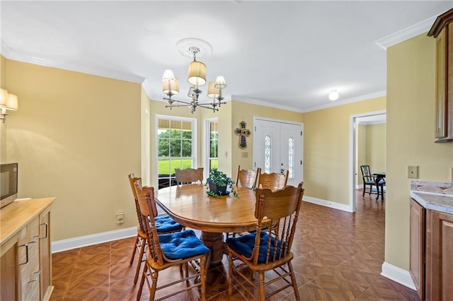 dining room with baseboards, a chandelier, and ornamental molding