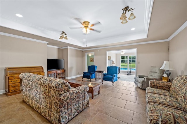 living room featuring ornamental molding, a raised ceiling, ceiling fan, and baseboards