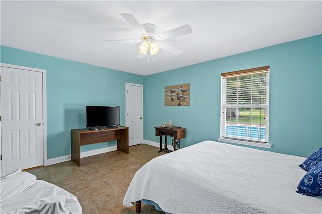 bedroom with ceiling fan and baseboards