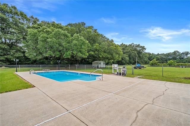 pool featuring a yard, a patio, and fence