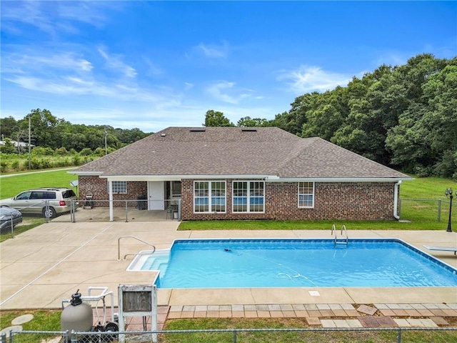 view of pool featuring a lawn, fence, a fenced in pool, and a patio