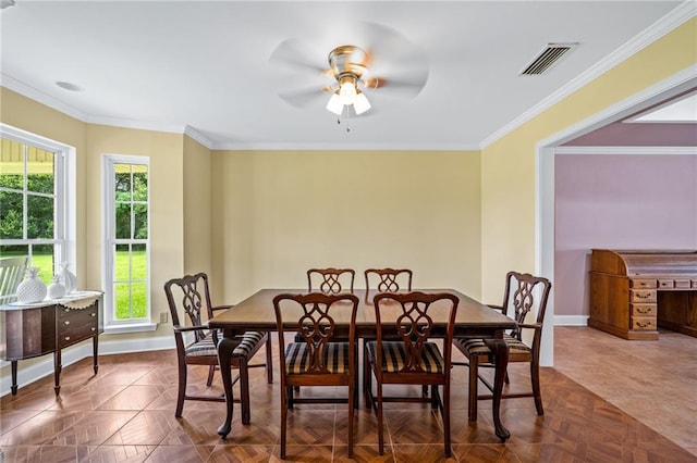 dining room featuring a ceiling fan, visible vents, crown molding, and baseboards