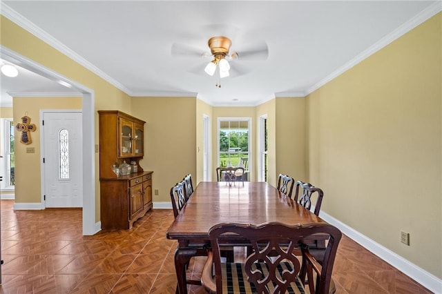 dining space featuring ceiling fan, baseboards, and ornamental molding