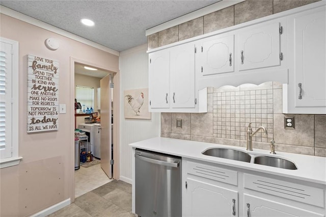 5719 Laurel Dr, Satsuma, AL 36572 - kitchen featuring stainless steel dishwasher, a sink, light countertops, white cabinetry, and a textured ceiling