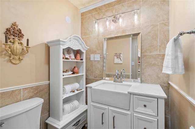 5719 Laurel Dr, Satsuma, AL 36572 - bathroom with tile walls, vanity, and toilet